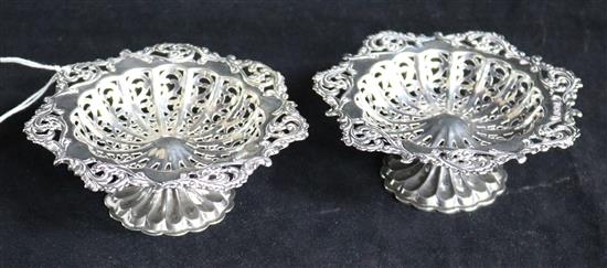 Two similar early 20th century pierced silver pedestal bonbon dishes.